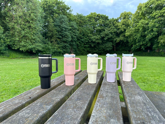 Mato London 40oz tumblers in multiple colours displayed outdoors – eco-friendly stainless steel travel mugs, perfect Christmas gift for coffee and tea lovers
